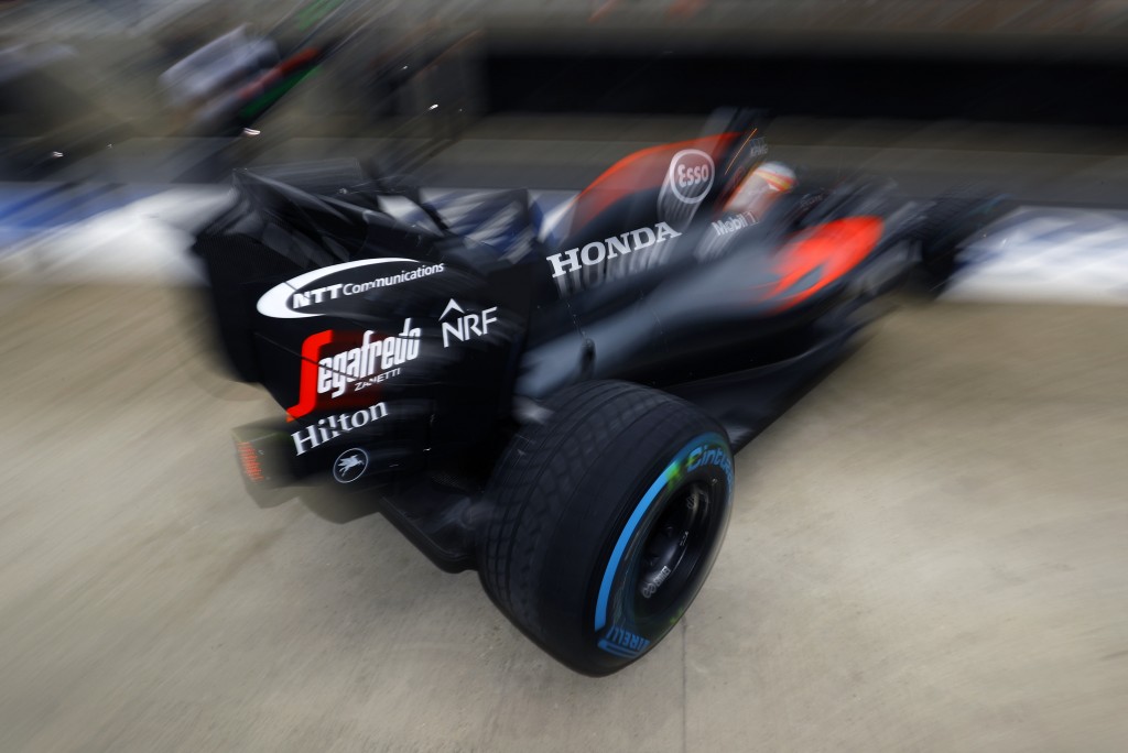 Fernando Alonso exits his pit garage.