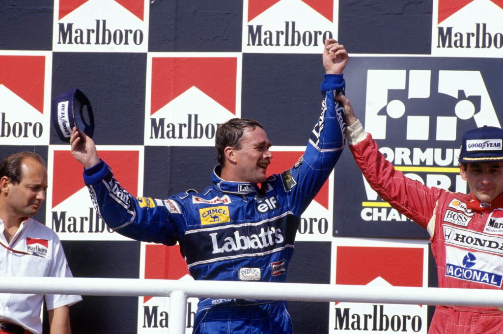Hungaroring, Hungary, 14th - 16th August 1992, RD11. 2nd placed Nigel Mansell celebrates victory in the race with winner Ayrton Senna. Portrait. Podium. Photo: LAT Photographic/Williams F1. Ref: 1992williams05