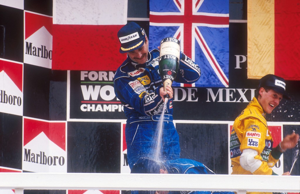 1992 Mexican Grand Prix. Mexico City, Mexico. 20-22 March 1992. Nigel Mansell, 1st position gives Riccardo Patrese 2nd position (both Williams Renault) a showering of champagne on the podium. Behind is Michael Schumacher (Benetton Ford) 3rd position.  Ref-92 MEX 06. World Copyright - LAT Photographic